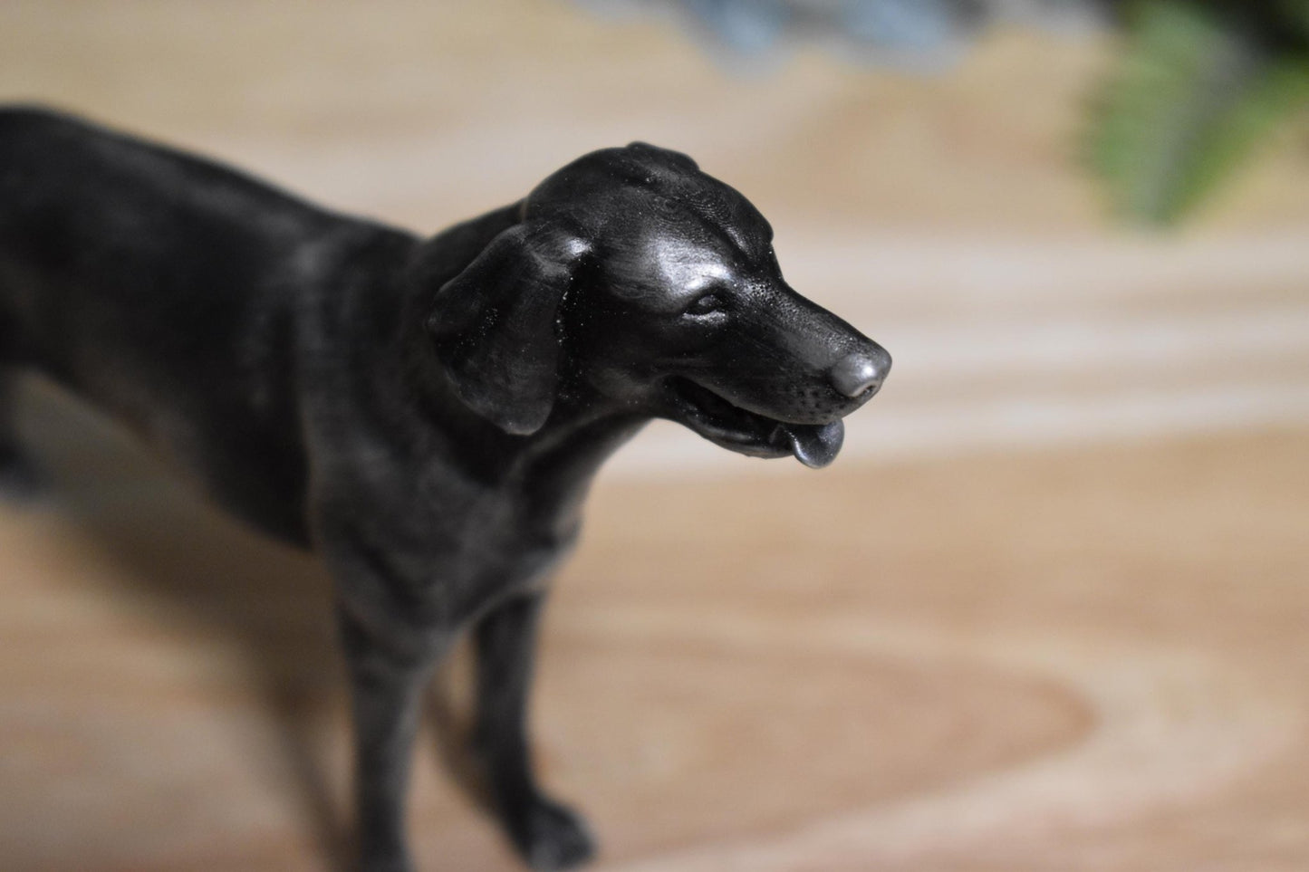 Right angled view of a black and silver American Foxhound standing statue, emphasizing its streamlined form