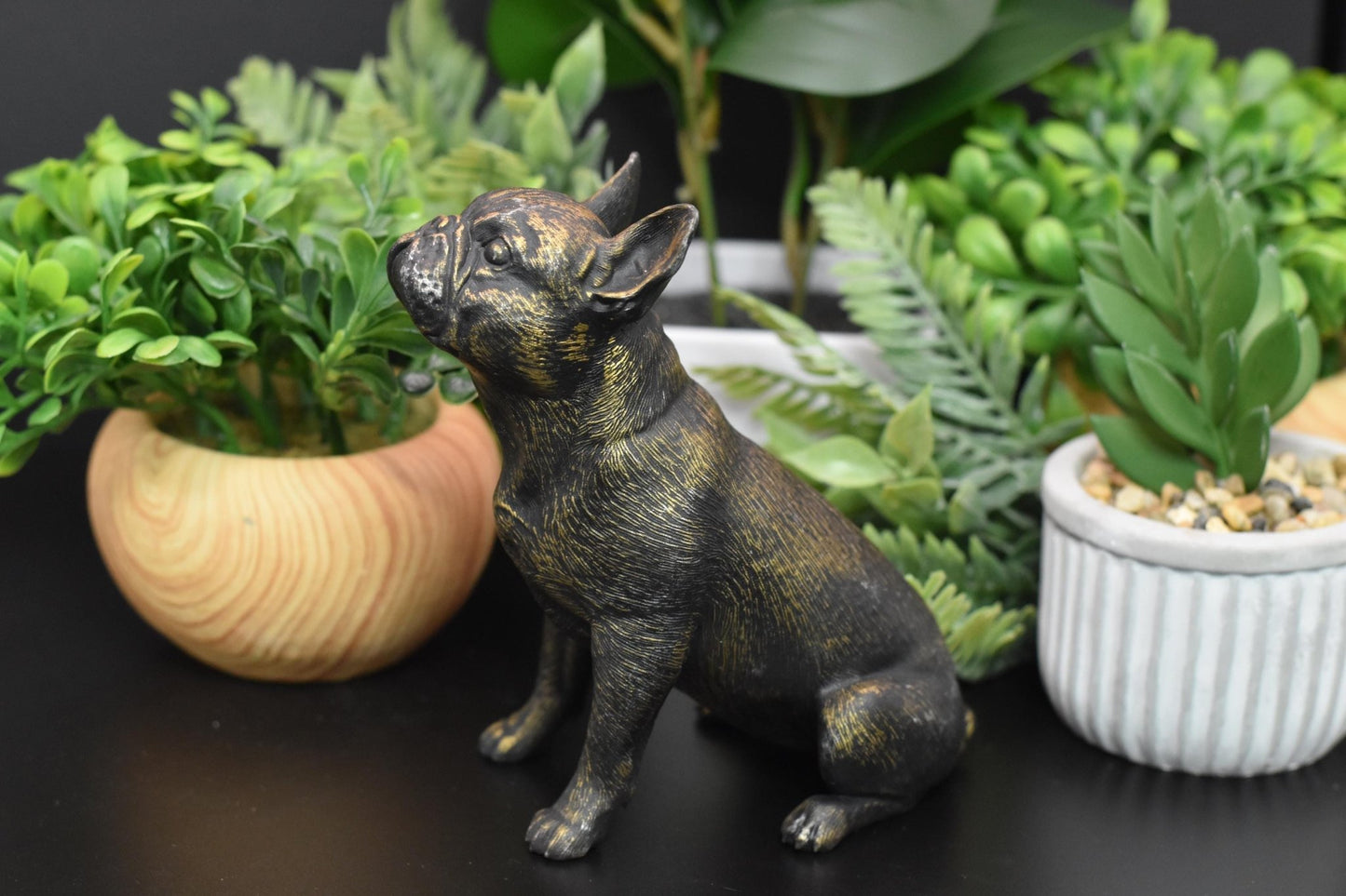 Left side of a detailed black and gold French Bulldog statue, capturing the breed’s charm.