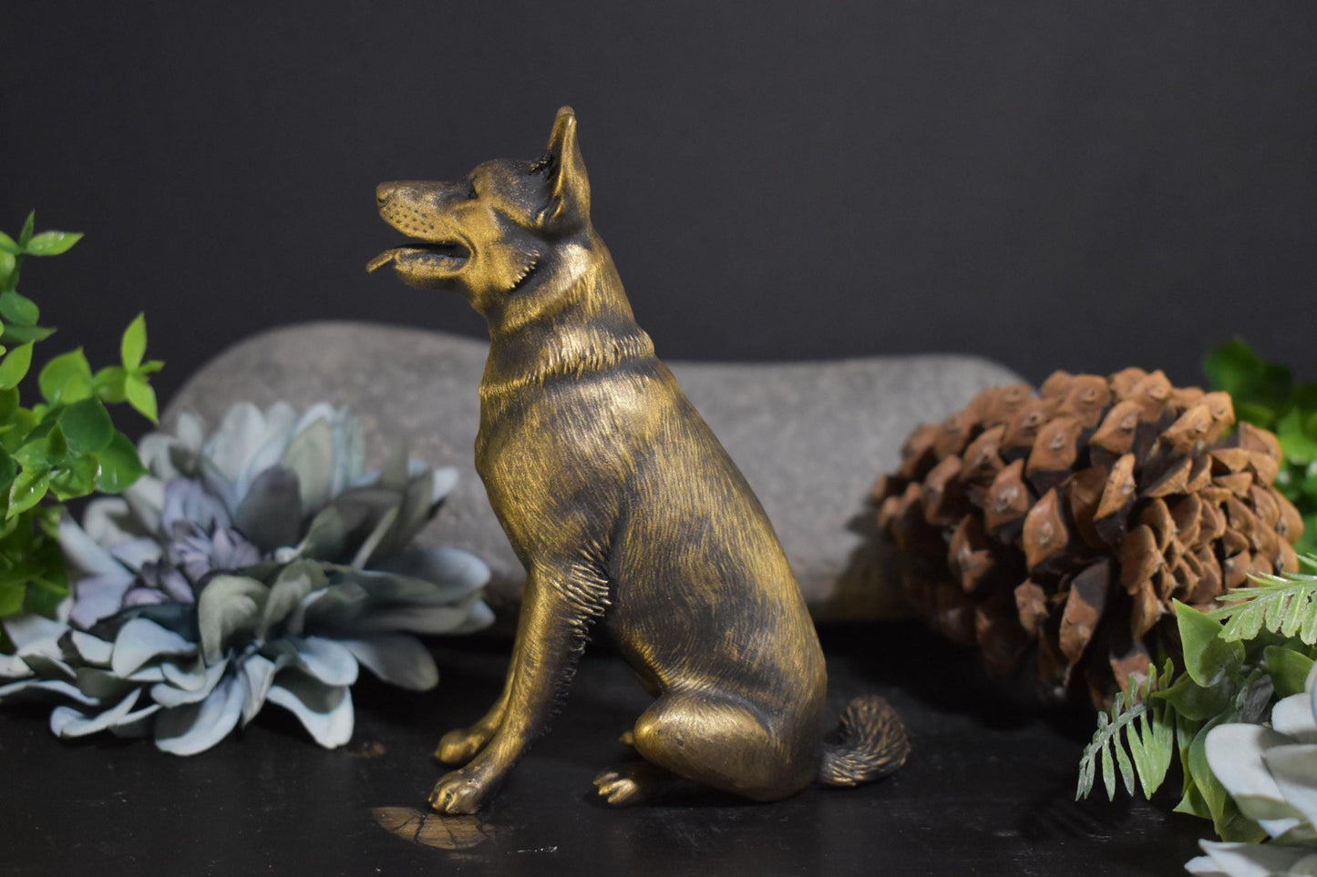 Left side of a black and gold German Shepherd sitting statue, perfect for collectors and dog lovers.