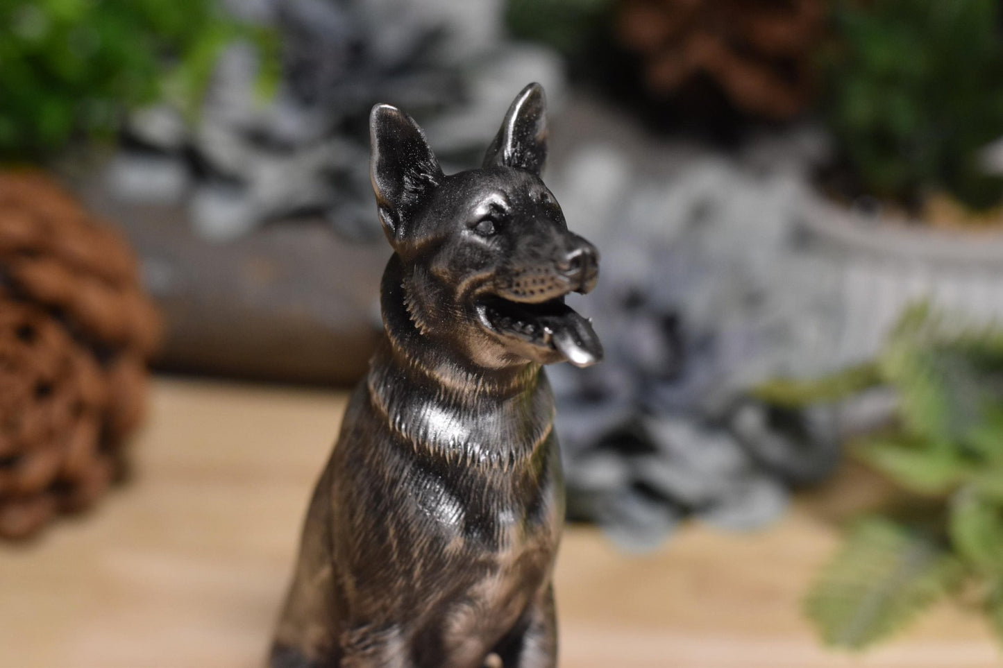 Close-up right side of a black and silver German Shepherd sitting statue, showing realistic details.