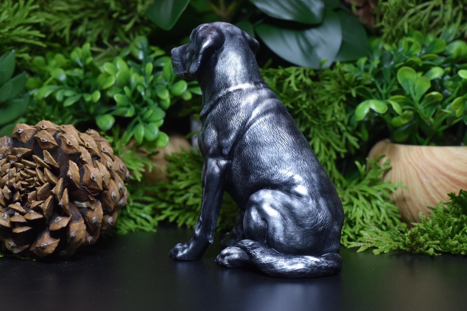 Back view of a black and silver Labrador sitting statue, showcasing detailed fur texture.